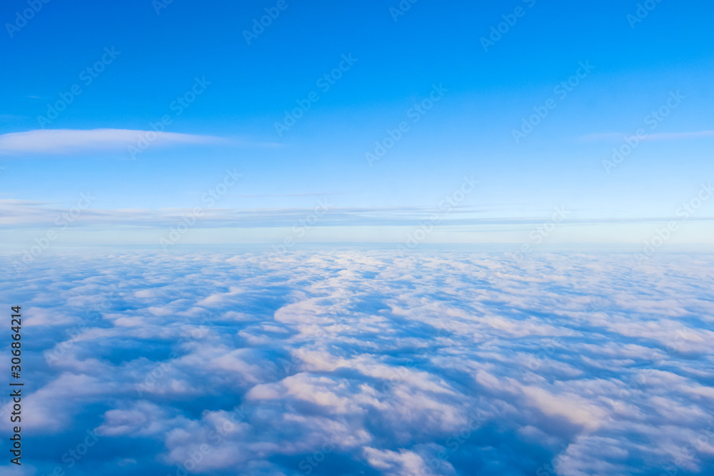Aerial view from an airplane on clouds and a blue sky. Tourism and Travel. Desktop backgrounds, textures. Aerial view from an airplane on clouds and a blue sky. Tourism and Travel. Desktop backgrounds, textures.