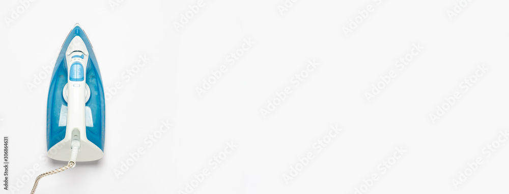 Iron for ironing things on a white isolated background. Laundry concept, tailoring studio, housework. Banner. Flat lay, top view Iron for ironing things on a white isolated background. Laundry concept, tailoring studio, housework. Banner. Flat lay, top view