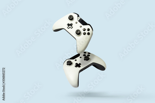 Flying air gamepads from a game console on a blue background. The concept of games, online games, e-sports. Levitation photo