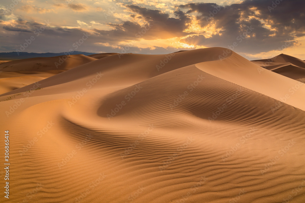 Sunset over the sand dunes in the desert