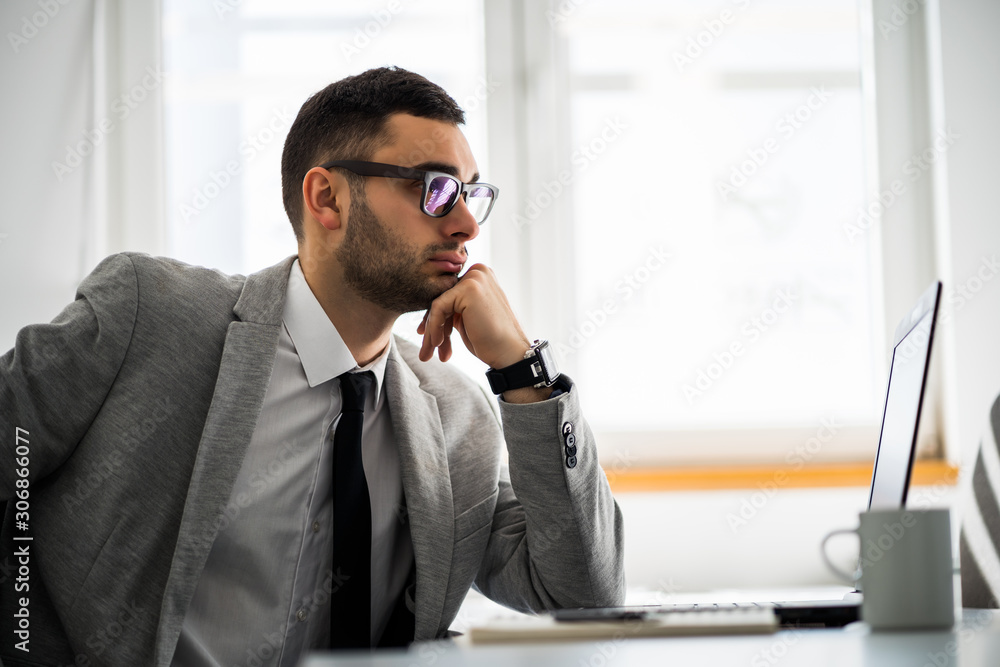 Young businessman is working in office. Young businessman is working in office.