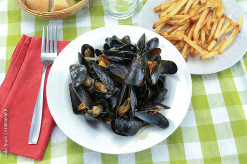 plate of mussels and fries on a table