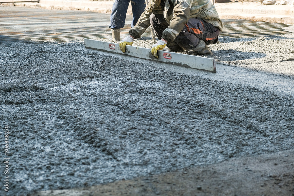 builders poured concrete at the construction site builders poured concrete at the construction site