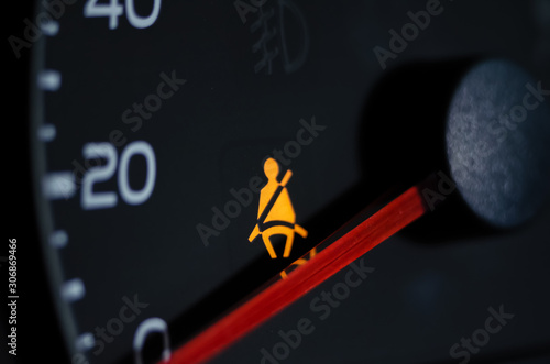 Yellow lit Warning lamp not wearing a seat belt close up photo