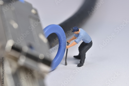 Tiny worker is working on a plug miniature repair scale