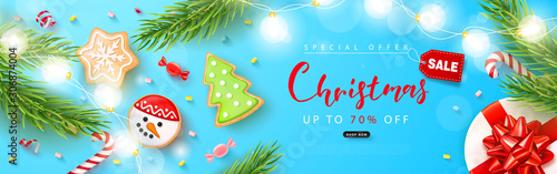 Merry Christmas sale banner. Holiday background with cookies, marshmallows, candy, gift box, fir branches and serpentine.Vector illustration for website,posters,ads,coupons,promotional material.