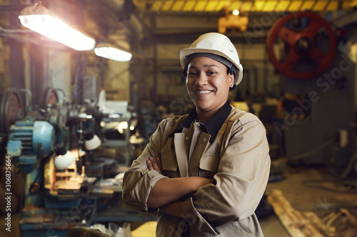 Fotografie Waist up portrait of mixed-race female worker posing confidently while standing