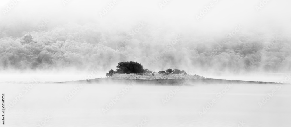 island in loch linnhe, highlands scotland in foggy conditions.