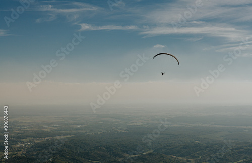 View of a paragliding in the sky. Paraglider flying over in The Nature Park Zumberak, Croatia 