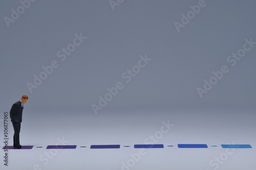 Mini business men standing on paper with blua and purple lines printed on it