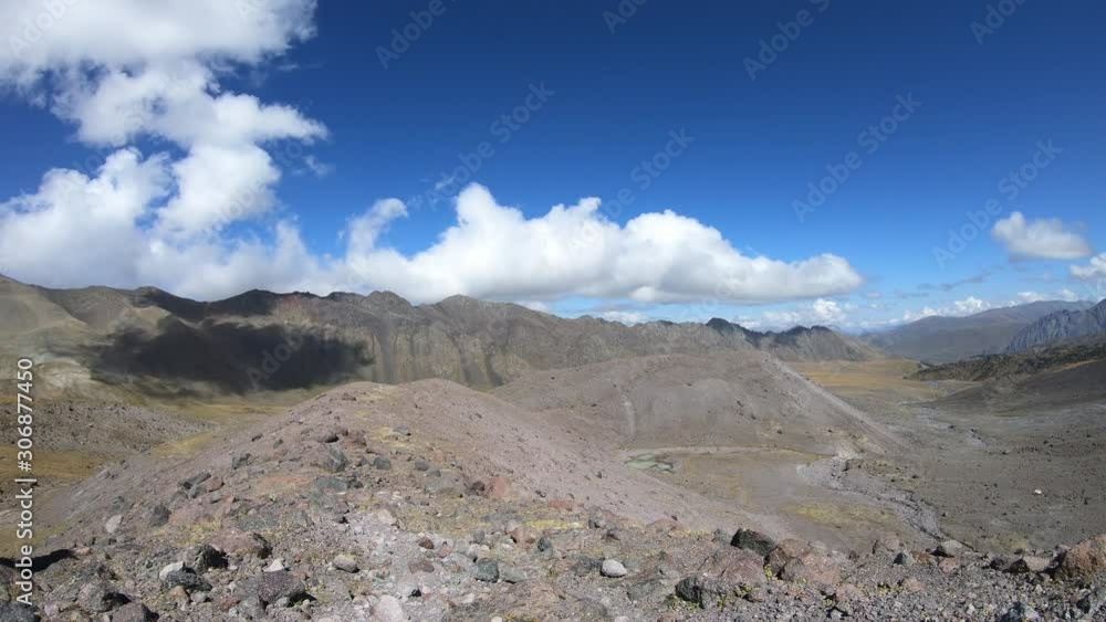 Time lapse of clouds flowing across the blue sky over the snowy tops of the mountains, Georgia, Caucasus. Mountain valley, nature of Georgia, Kazbegi. Clouds in rocky mountains Time lapse of clouds flowing across the blue sky over the snowy tops of the mountains, Georgia, Caucasus. Mountain valley, nature of Georgia, Kazbegi. Clouds in rocky mountains