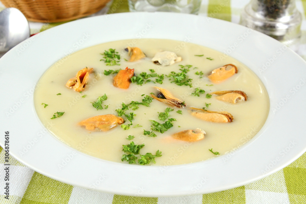 plate of mussel soup on a table