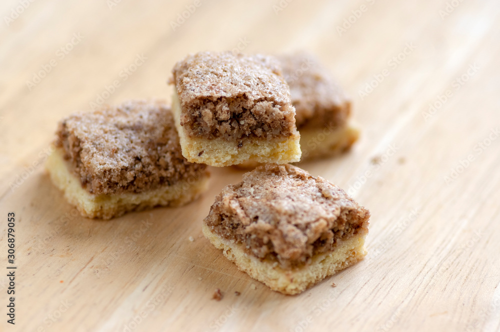 London cubes Christmas cookies on wooden table, group of simplicity winter sweets with walnuts and jam