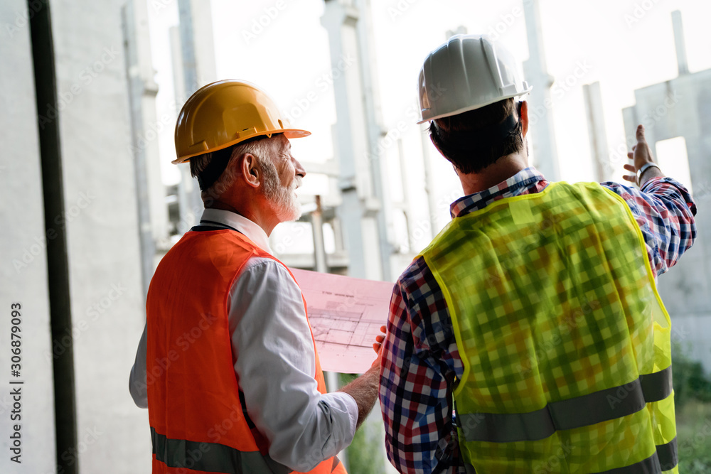 Architect and construction engineer or surveyor discussion plans and blueprints Architect and construction engineer or surveyor discussion plans and blueprints