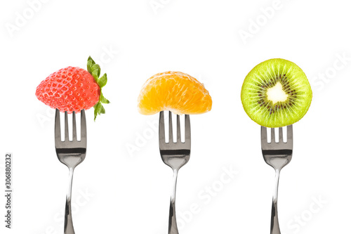 Forks with fruits isolated on white background