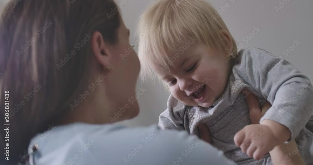 Portrait of laughing baby girl playing with mother. Young Caucasian woman throwing up daughter in the air. Happiness, leisure, tenderness, lifestyle Cinema 4k ProRes HQ. Portrait of laughing baby girl playing with mother. Young Caucasian woman throwing up daughter in the air. Happiness, leisure, tenderness, lifestyle Cinema 4k ProRes HQ.