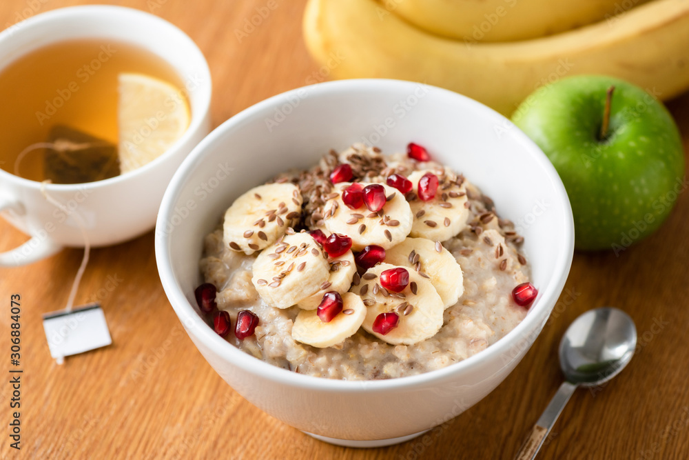 Oatmeal porridge and green tea with lemon on wooden table. Healthy breakfast food Oatmeal porridge and green tea with lemon on wooden table. Healthy breakfast food