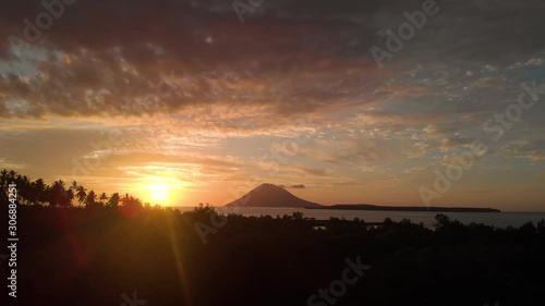 Golden sunset over a oceanic volcano in tropical waters photo