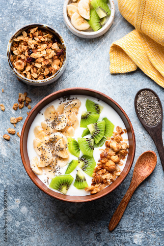 Smoothie or smoothy bowl with granola, fruits and seeds. Superfood breakfast bowl