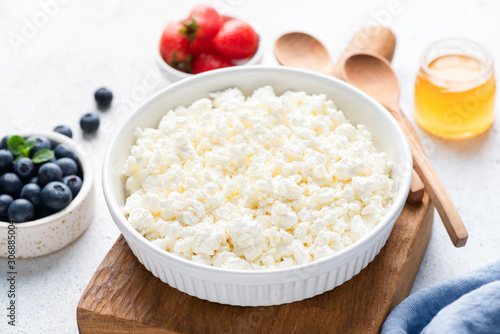 Cottage cheese or ricotta in bowl. Healthy food, dairy product with high calcium and rich protein
