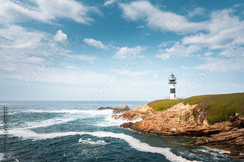Lonely lighthouse on the coast of Galicia, Spain. Island of Pancha near Ribadeo