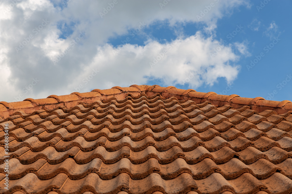 roof top on sky background. Close up of brown clay roof tiles. Red old dirty roof. Old roof tiles. Construction equipment build a house. roof top on sky background. Close up of brown clay roof tiles. Red old dirty roof. Old roof tiles. Construction equipment build a house.