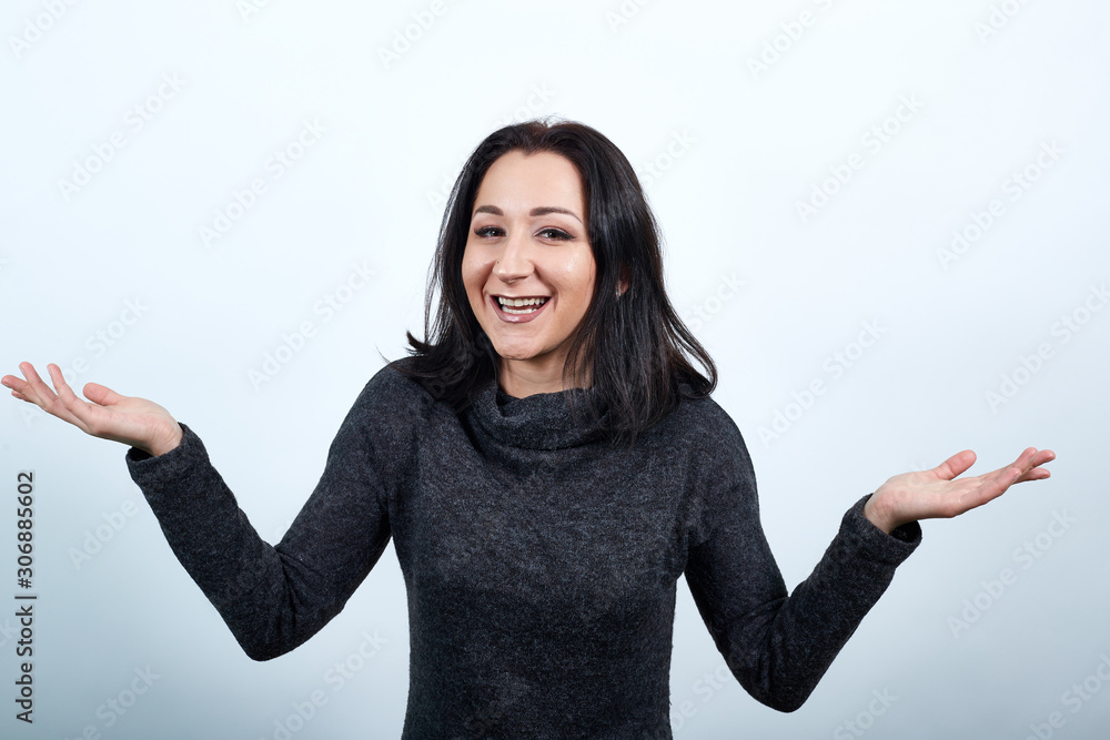 Caucasian young woman in fashion black spreads hands, smiling, looking pretty over isolated white background, Lifestyle concept Caucasian young woman in fashion black spreads hands, smiling, looking pretty over isolated white background, Lifestyle concept