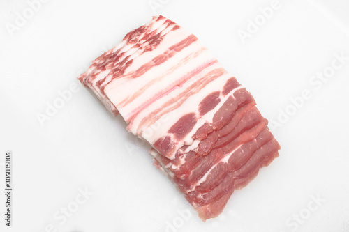 Sliced pork belly on a white background