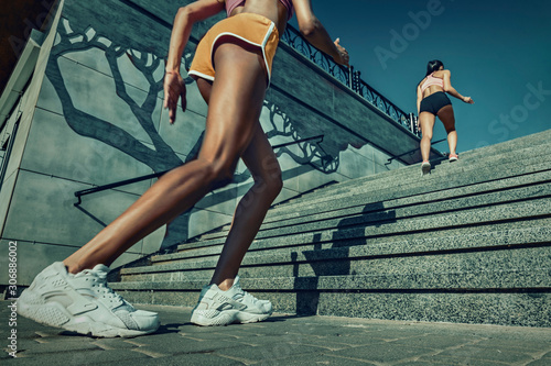 Athletic young women jogging up the stairs.