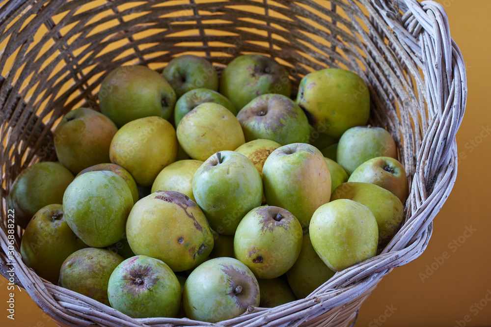 Basket of organic apples on a brown background. Basket of organic apples on a brown background.