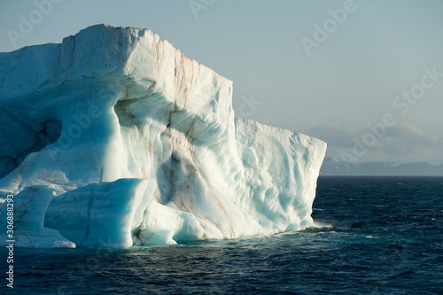 A large iceberg drifts at sea in Arctic Ocean having detached from a glacier.Climate Crisis.Image