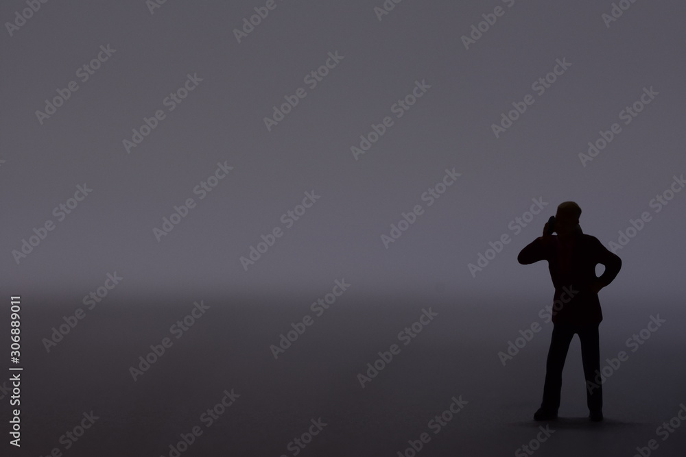 Obraz premium mini man talking on a mobile phone