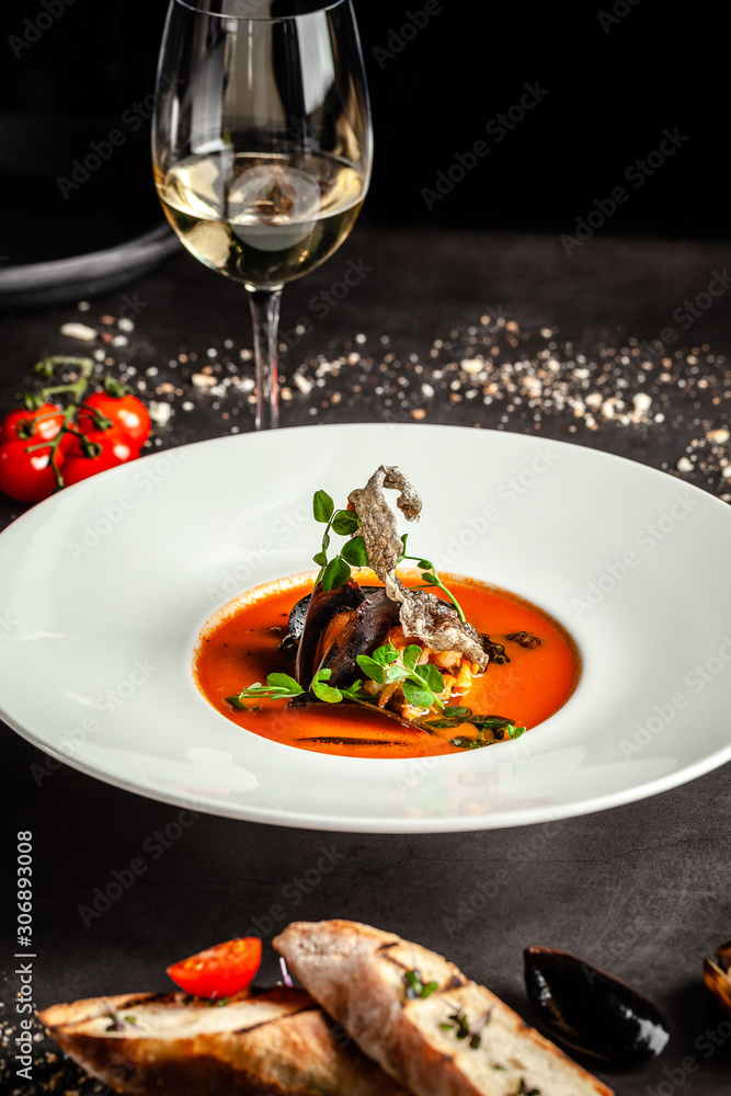 Spanish food concept. Gazpacho tomato soup with seafood, mussels and white wine. Background image.  copy space