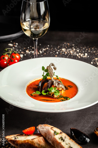 Spanish food concept. Gazpacho tomato soup with seafood, mussels and white wine. Background image. copy space