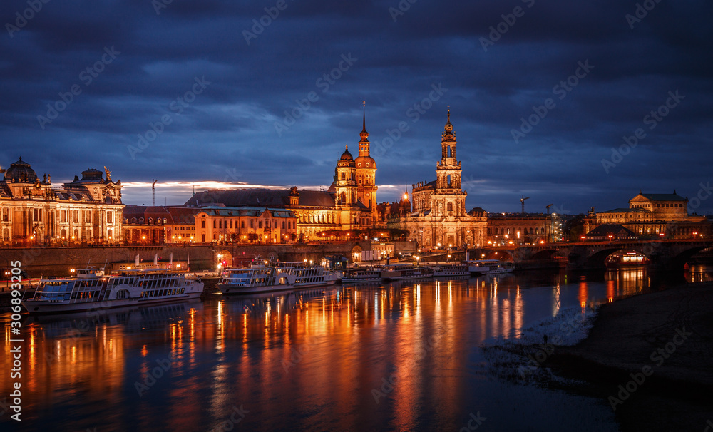 Awesome colorful scene during sunset  at the Old Town in Dresden, Saxony, Germany. Famouse Sights: Frauenkirche, Hofkirche, Semperoper with reflected in calm water Elbe river.  Postcard