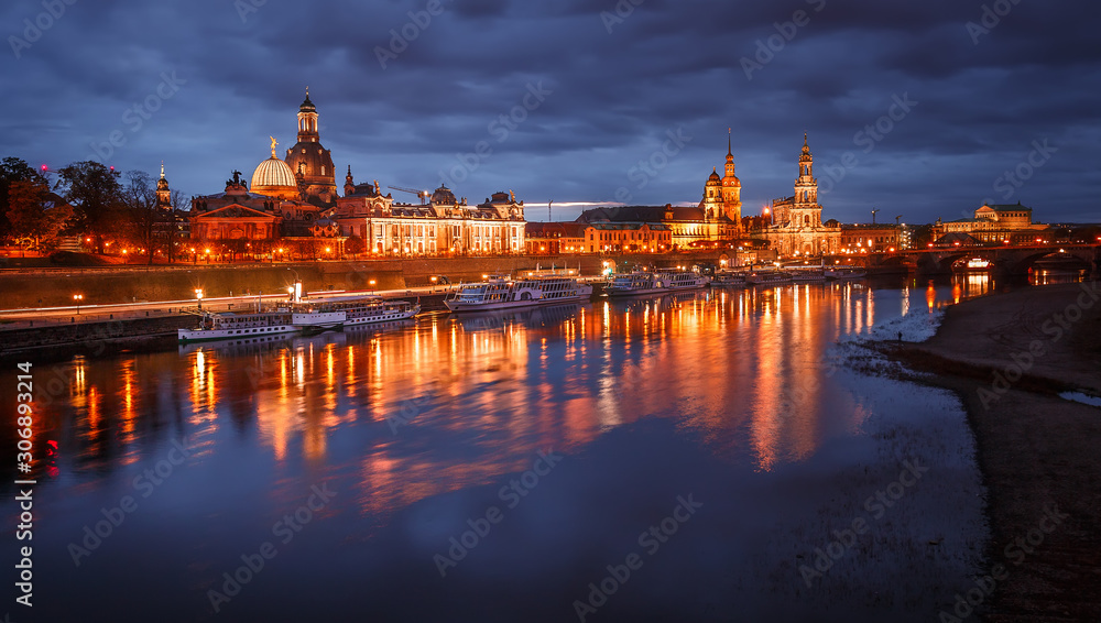 Awesome colorful scene during sunset  at the Old Town in Dresden, Saxony, Germany. Famouse Sights: Frauenkirche, Hofkirche, Semperoper with reflected in calm water  Elbe river. picturesque scenery.