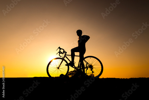cyclist and Bicycle silhouettes on the dark background of sunsets. ride bicycle on sunset background.