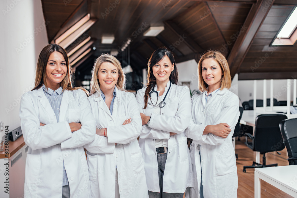 Beautiful female medical team standing with crossed arms. Beautiful female medical team standing with crossed arms.