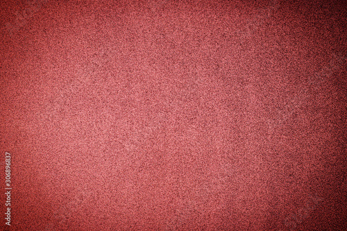 Christmas rose gold background. Red paper background. Metallic glitter noise red background, close up. 