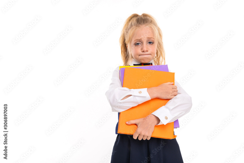 blonde girl holds books against a white wall blonde girl holds books against a white wall