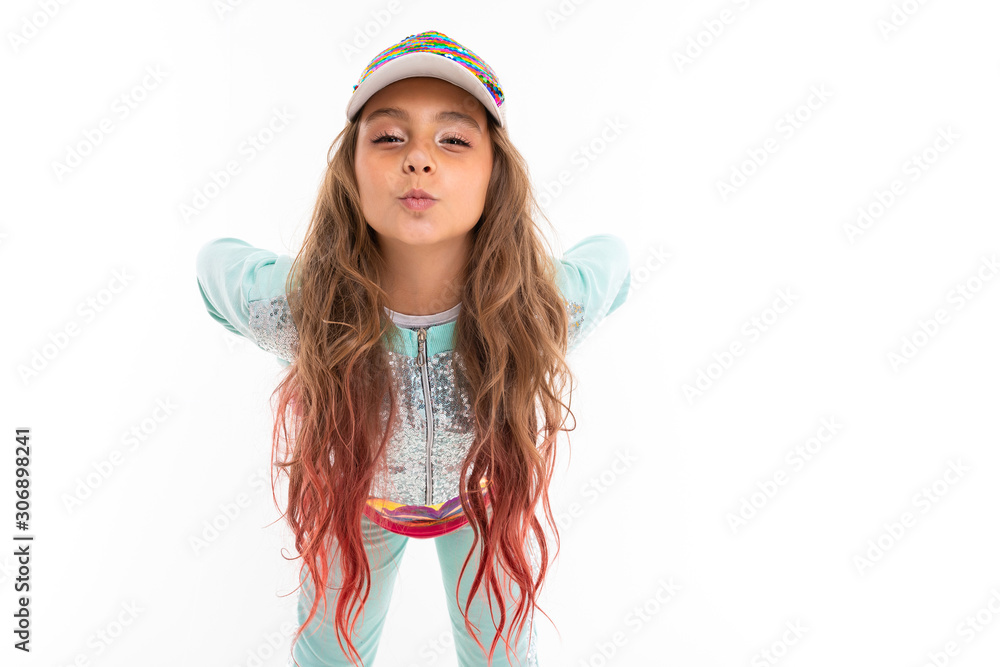 Little pretty caucasian girl in a tracksuit blows a kiss, picture isolated on white background Little pretty caucasian girl in a tracksuit blows a kiss, picture isolated on white background