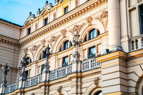 Side view of monumental, rich decored with sculptures and ornaments building of Juliusz Slowacki Theatre in Cracow (Krakow) old town in Poland at dusk