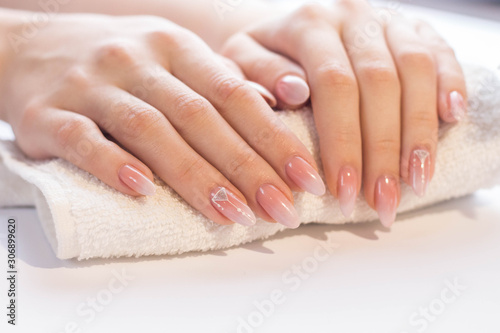 Beautiful soft woman hands with light manicure hand care and spa relaxing