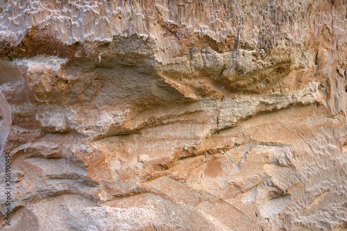 Cross section of sandy soil, relief vertical cut closeup, textured background image