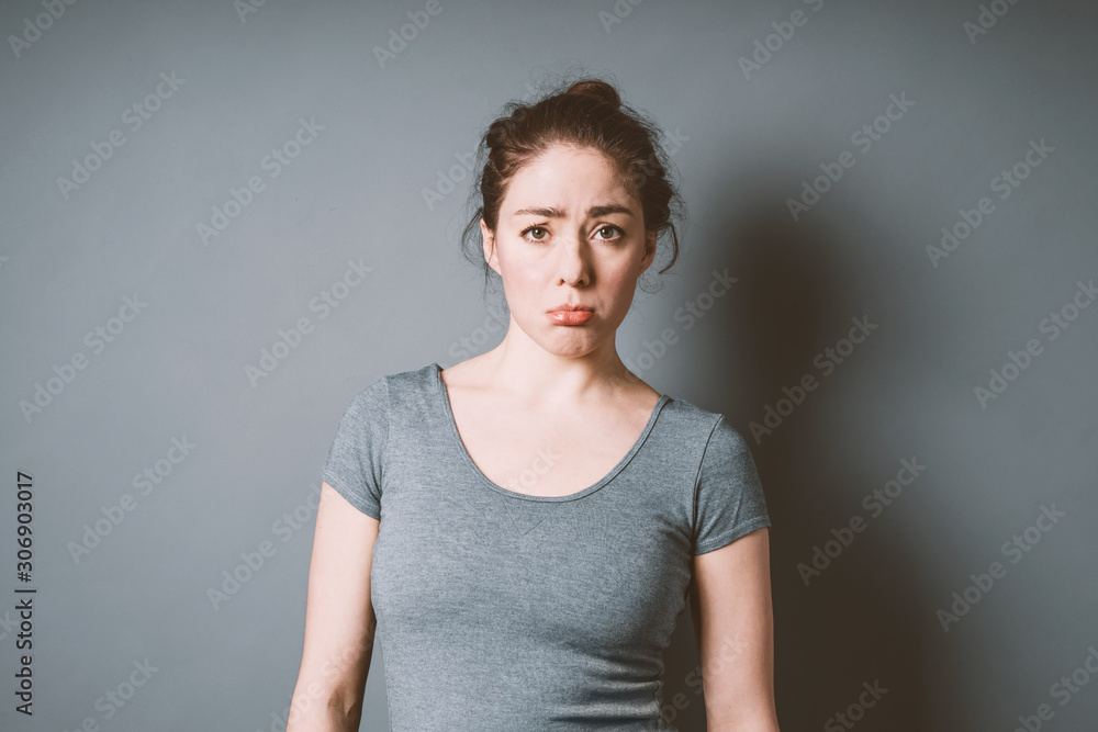 sulky pouting young woman in her 20s feeling letdown and disappointment - negative emotion bad mood concept with copy space sulky pouting young woman in her 20s feeling letdown and disappointment - negative emotion bad mood concept with copy space