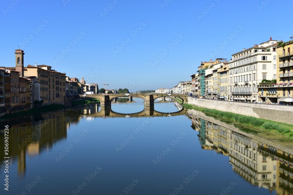 View of Arno river with Ponte Santa Trinita from Ponte Vecchio. Florence, Italy. The oldest elliptic arch bridge in the world.