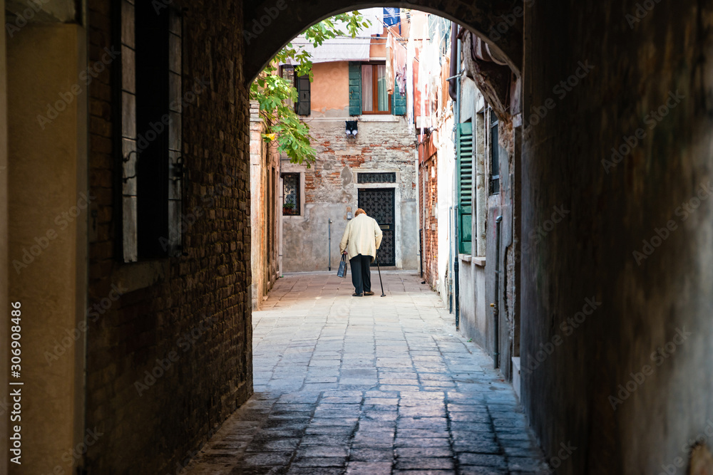 Street life in Venice. Old woman walk in castello district Street life in Venice. Old woman walk in castello district