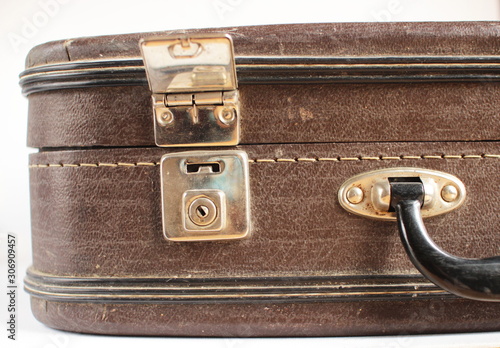 Vintage things concept. Fragment of old brown suitcase on white background closeup. Copy space for text.