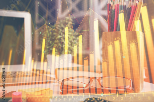 Financial chart hologram with glasses on the table background. Concept of business. Double exposure. © peshkova
