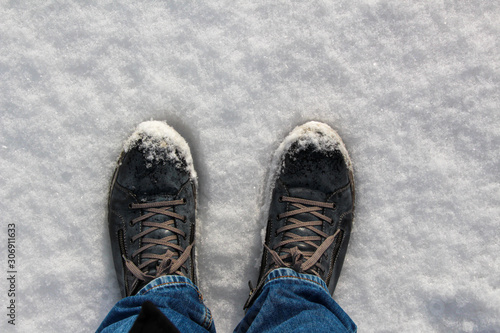 Blue warm shoes in the winter in the snow